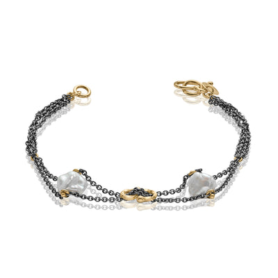 Hannako Lily Petit Lockande svart silver armband med guld och pärlor.
